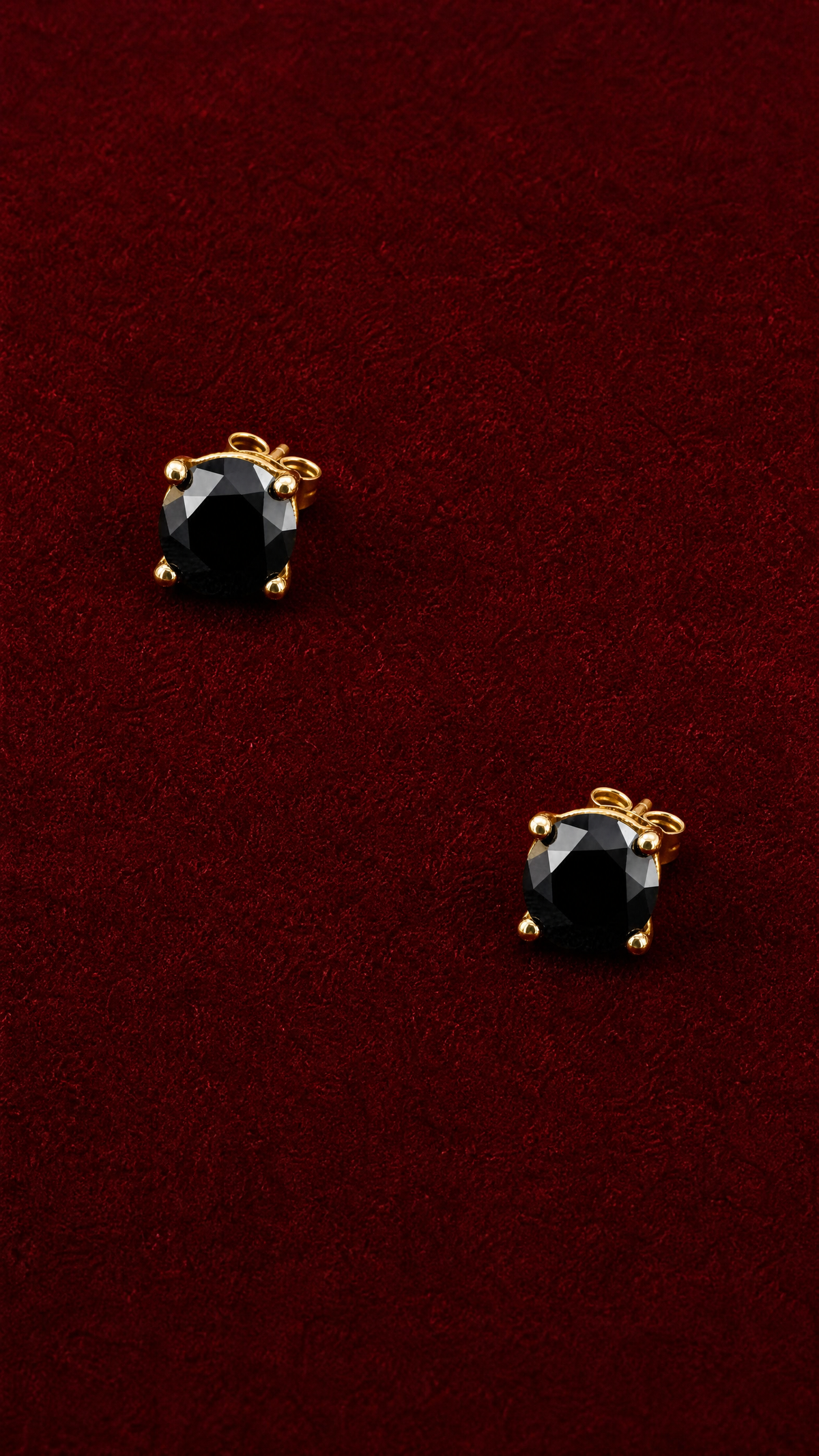 Persephone black moissanite studs on red velvet